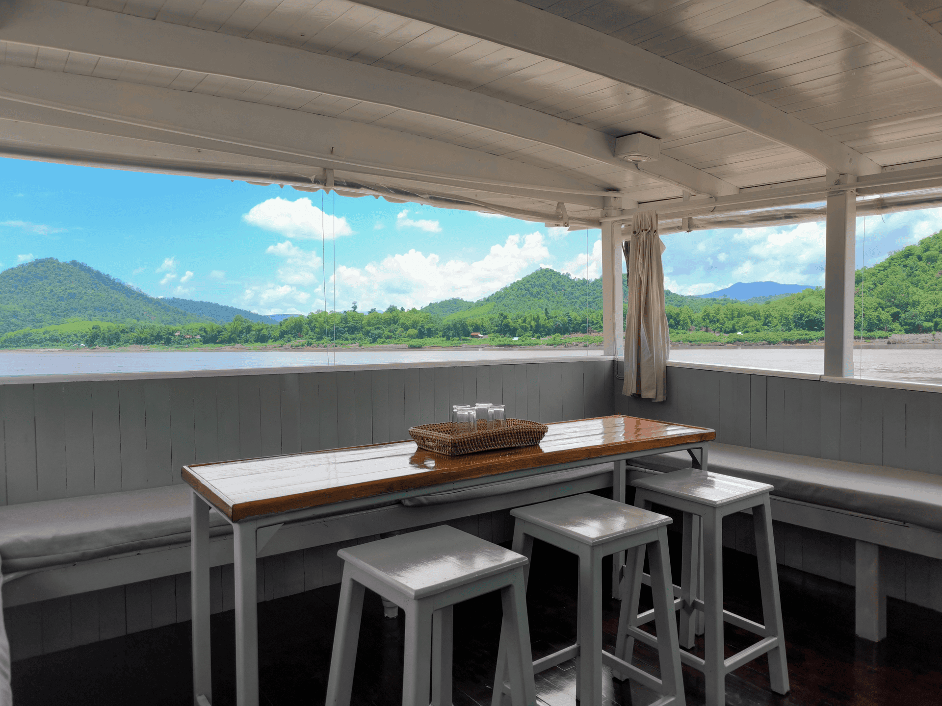 Traditional teak boat cruising the Mekong River